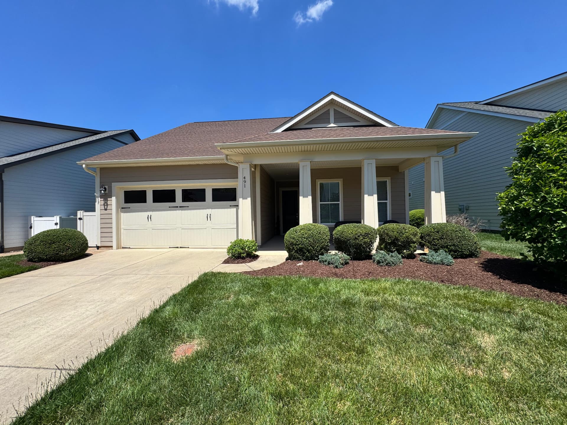 Neatly maintained front lawn and foundation shrubs