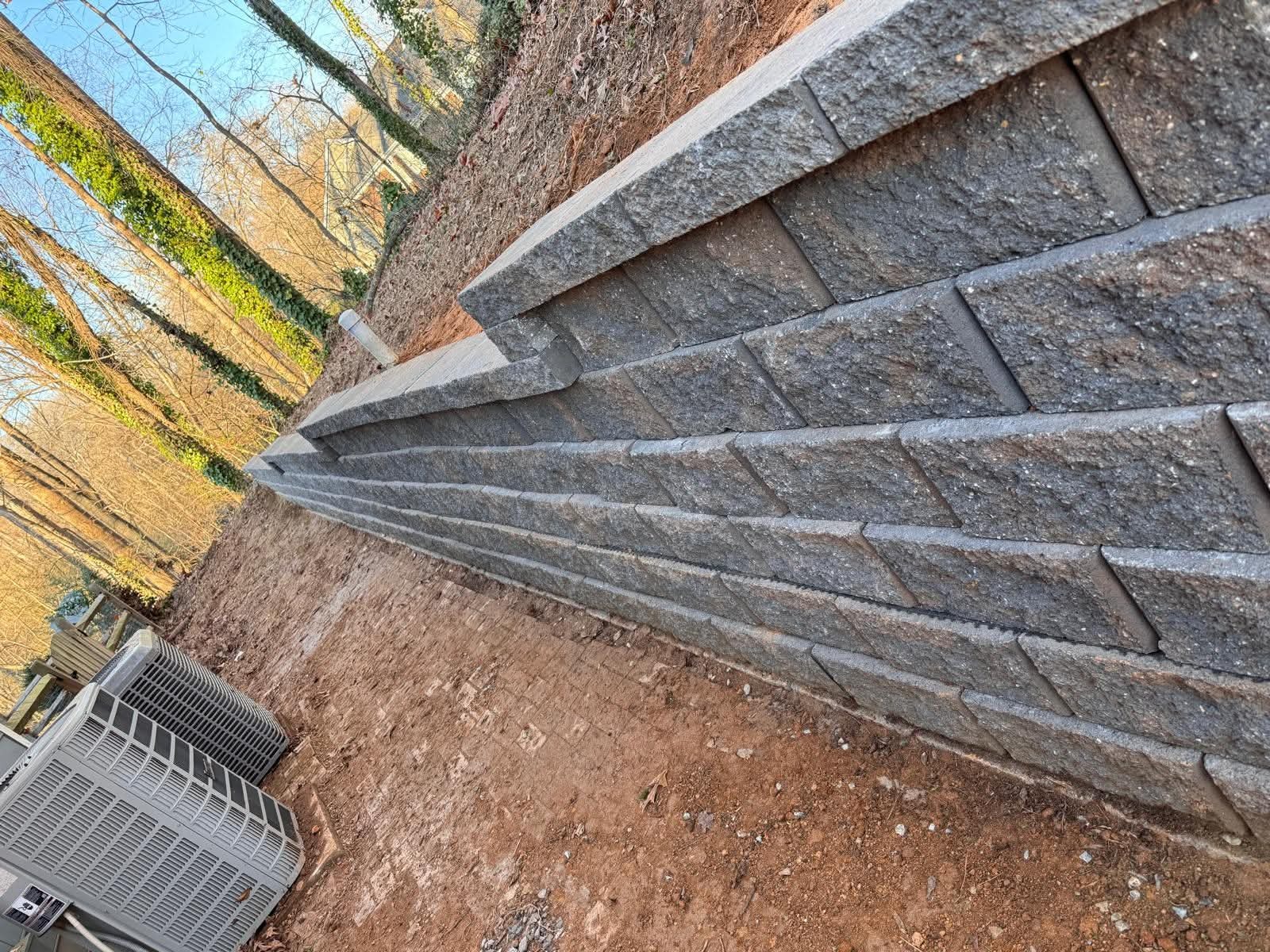 Close view of a block retaining wall beside a home