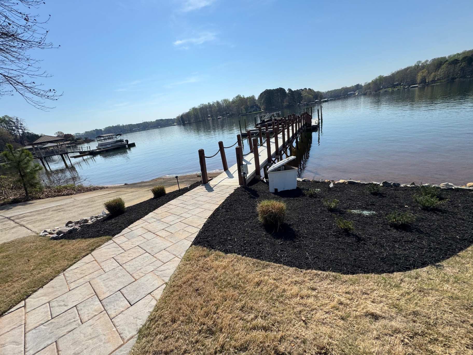 Mulched trees and shrubs at a lakeside property