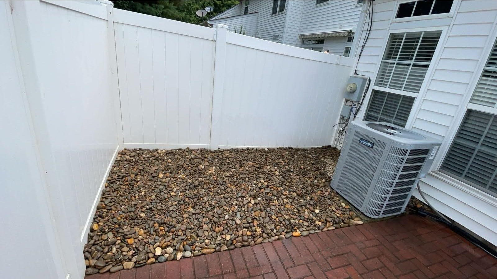 River rock bed in a fenced side yard