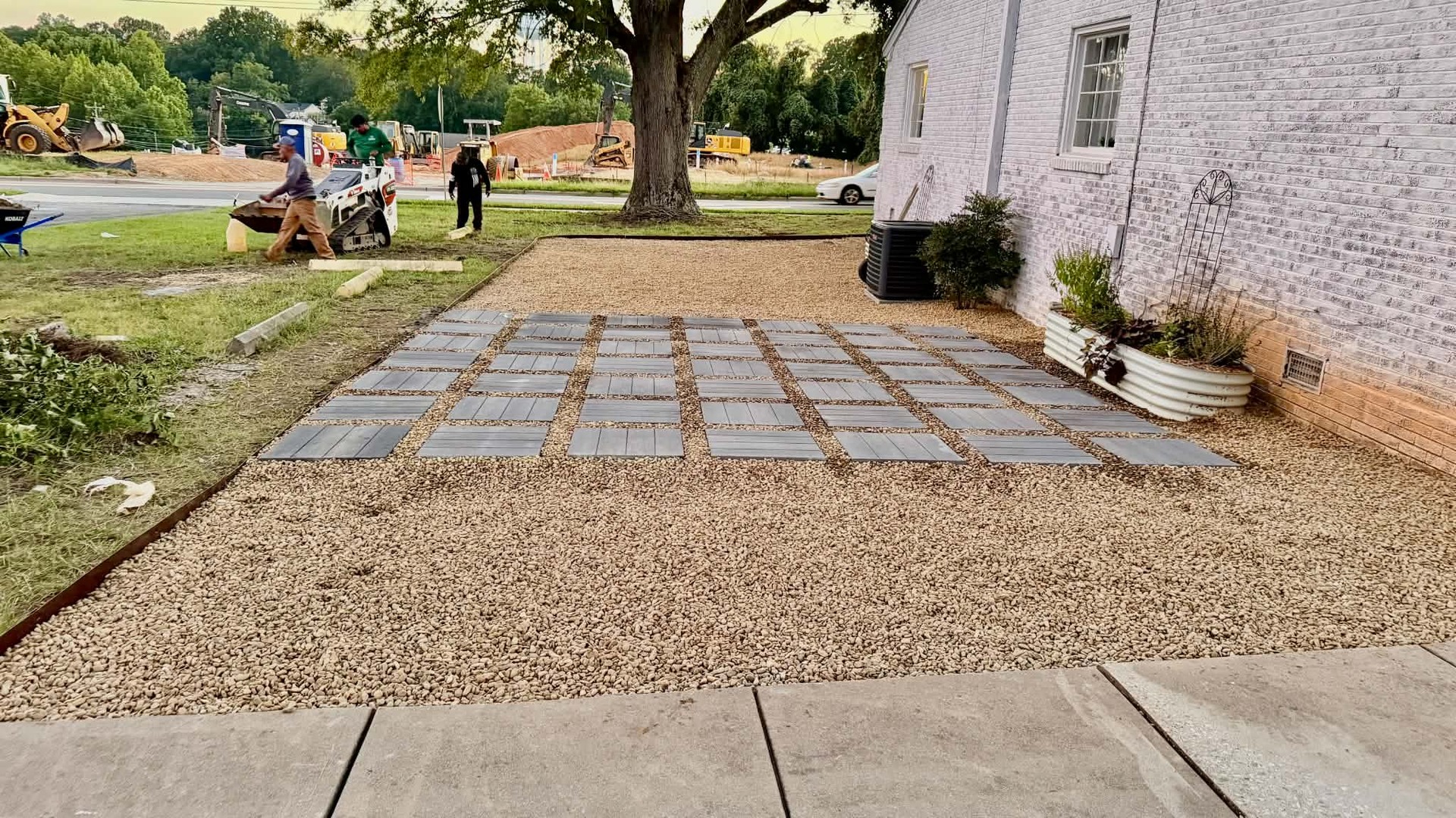 Square stepping stones set into a gravel garden patio