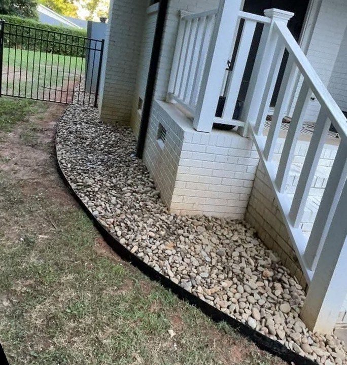 River rock border around porch steps