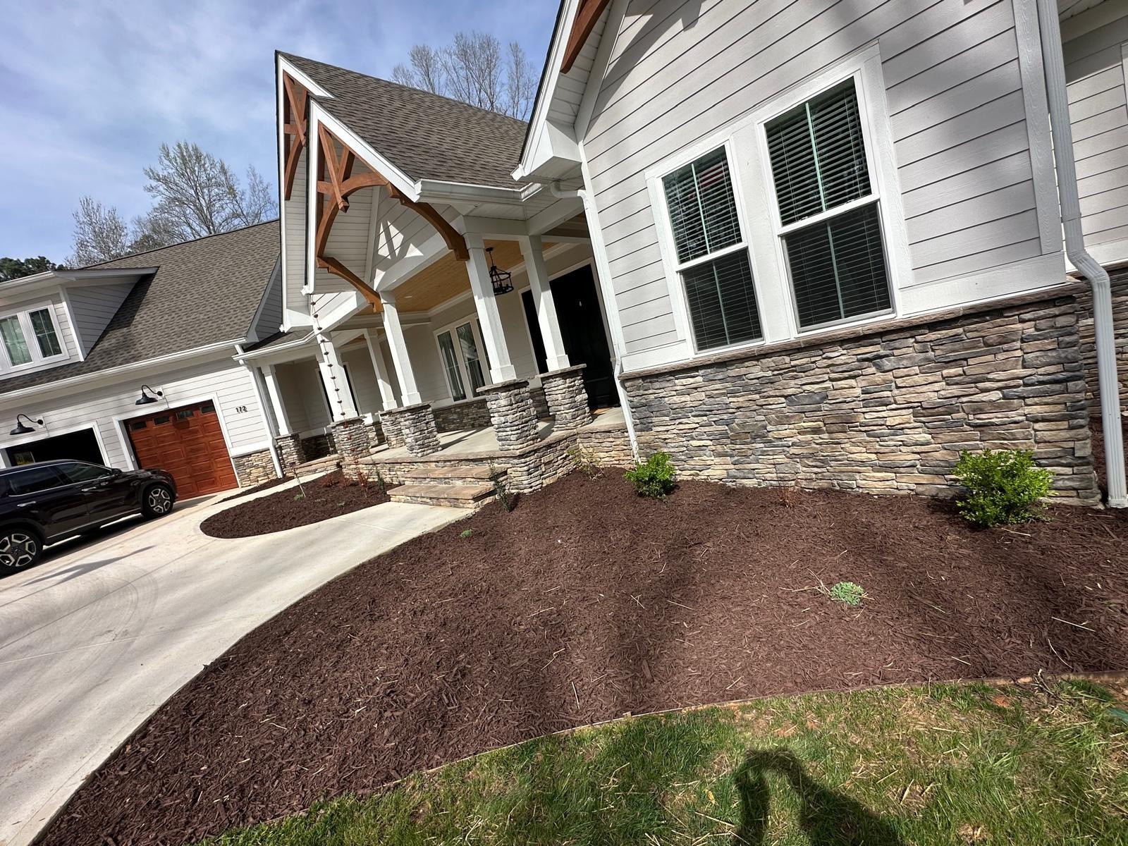 Freshly prepared foundation planting bed at a gray home