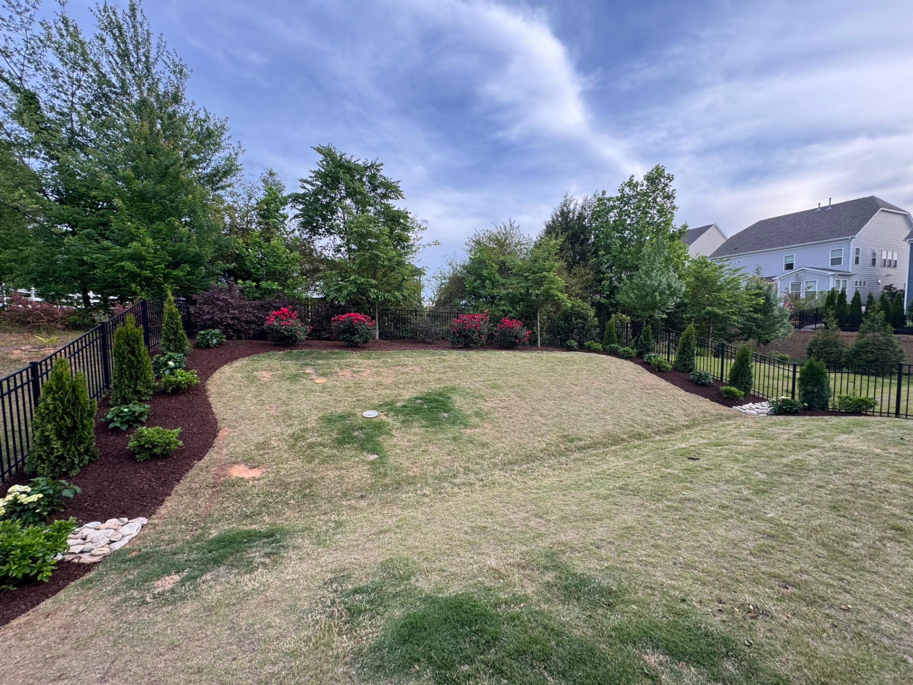 Lawn bordered by curved mulched garden beds