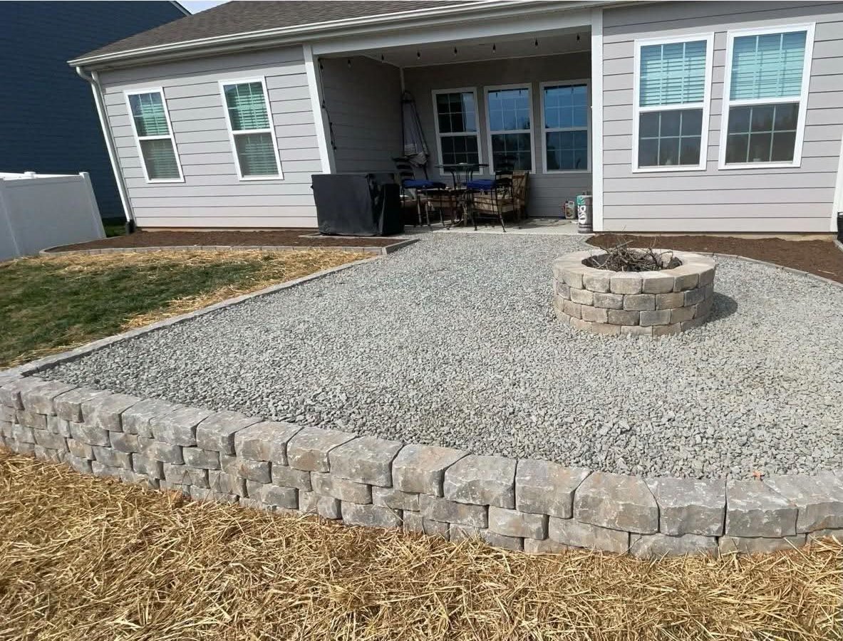 Gravel fire pit area with a block border